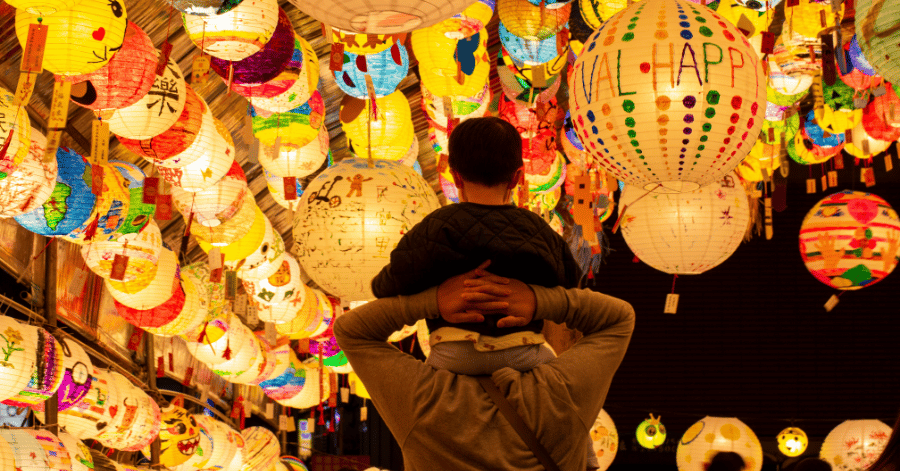 Colourful hand-painted paper lanterns glowing overhead as visitors look up at the Taiwan Lantern Festival