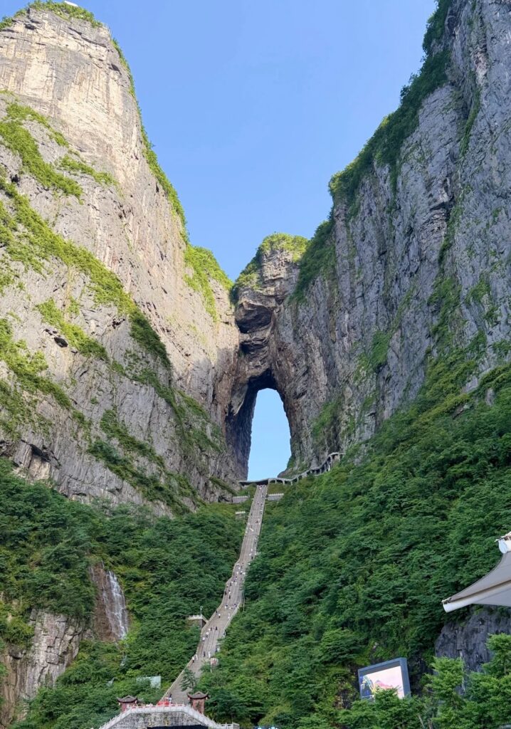 The Tianmen Cave arch through the cliff with the 999-step staircase climbing to it