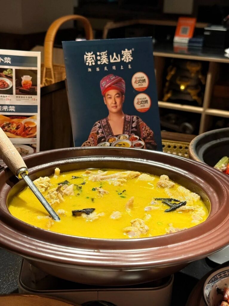 A clay pot of golden free-range chicken soup stewed with dark rock-ear lichen