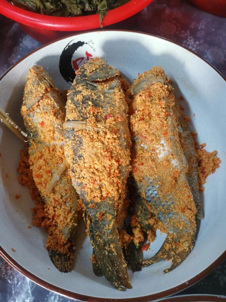 Whole river fish coated in fermented chilli-rice powder, a Xiangxi sour speciality