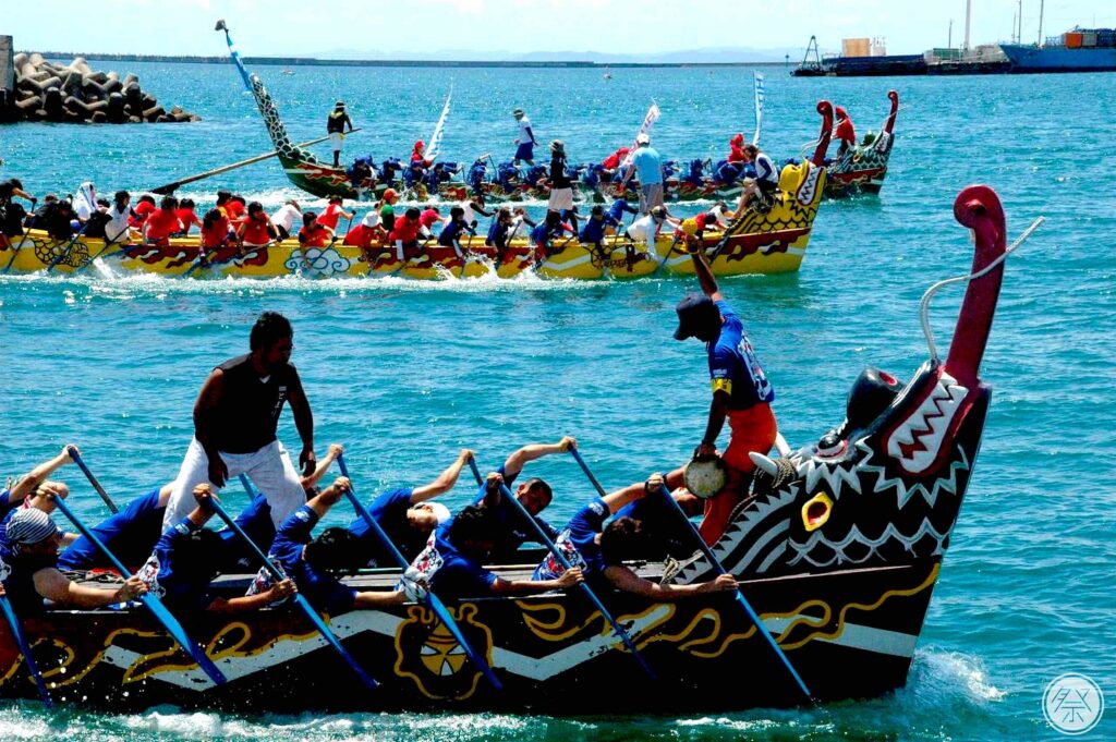 Teams rowing brightly painted dragon boats during a harbour race in Okinawa