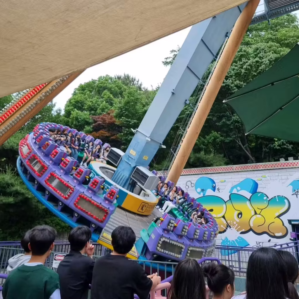 Everland's Hurricane ride swings a ring of riders as spectators watch from below