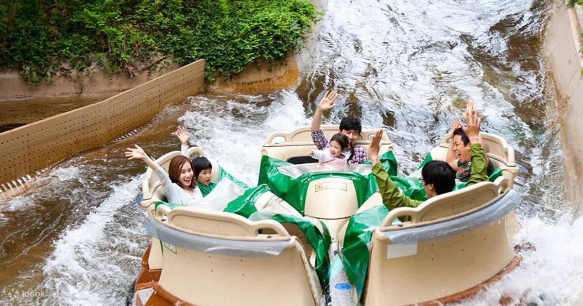 Family in a circular Amazon Express raft with a green tarp riding through white water