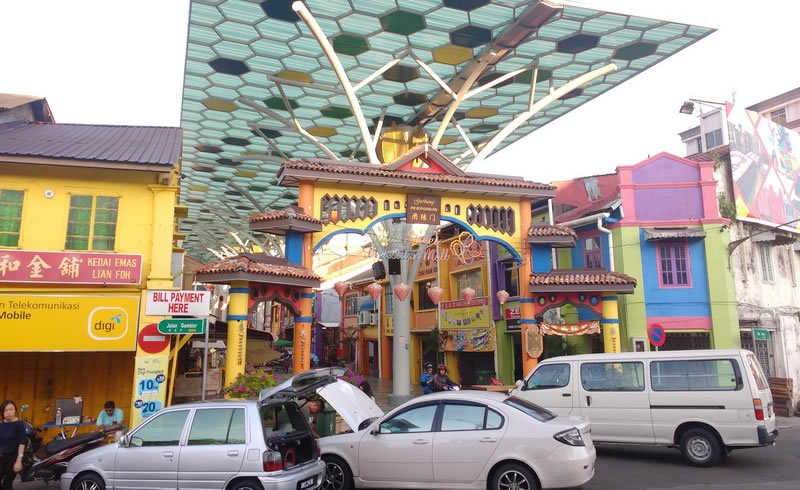 Covered walkway with hexagonal canopy and colourful shophouses along India Street