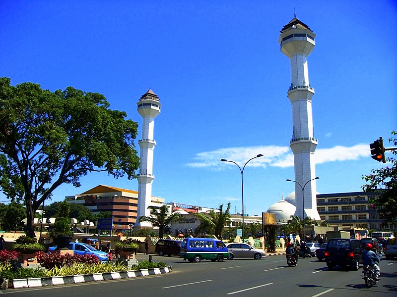The two white minarets of Bandung's Grand Mosque rising above traffic on the main square
