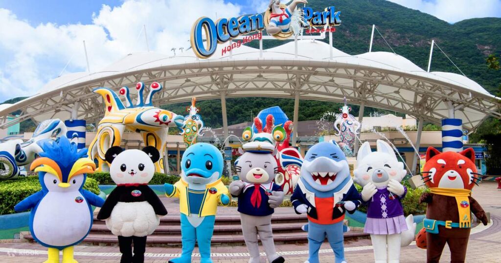 Ocean Park's seven costumed animal mascots lined up in front of the main entrance arch