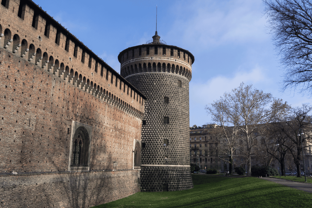 Round stone tower and brick ramparts of Castello Sforzesco, Milan
