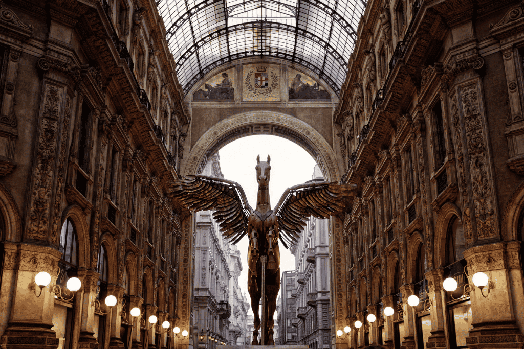 A golden winged-horse sculpture beneath the arcade of the Galleria Vittorio Emanuele II, Milan