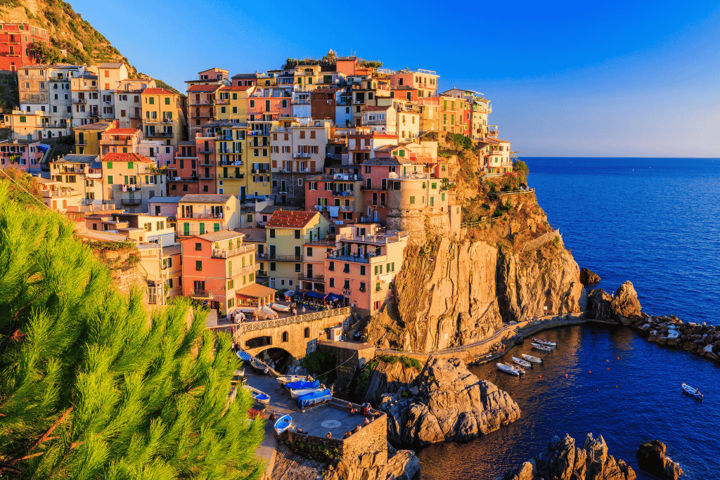 Pastel houses stacked on the cliffs above the harbour at Manarola, Cinque Terre