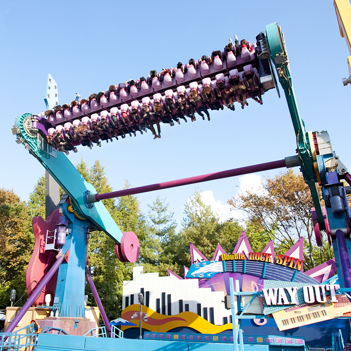 Double Rock Spin flips a row of riders upside down beside its guitar-themed sign