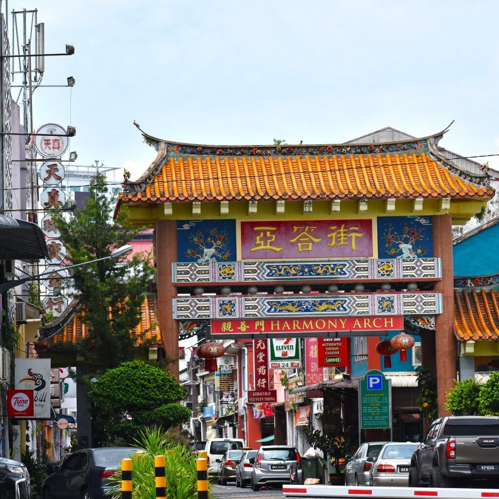 Ornate Chinese gateway with orange tiled roof marking the entrance to Carpenter Street
