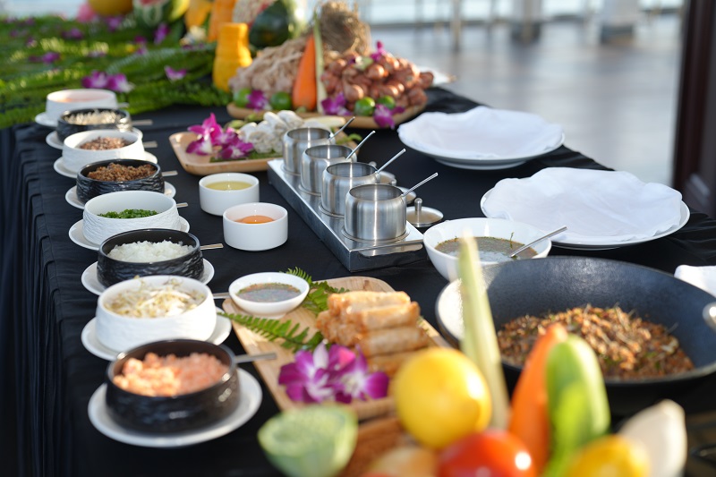 Prep bowls, herbs, rice paper and spring rolls laid out for a cooking demonstration