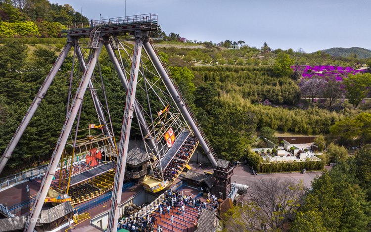 Columbus Adventure swinging ship viewed from above with pink azalea slopes beyond