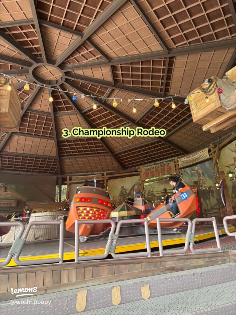 Orange Championship Rodeo cars spinning under a timber pavilion roof at Everland