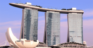 Marina Bay Sands towers and the lotus-shaped ArtScience Museum against a pink dawn sky in Singapore