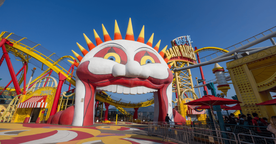 The grinning sun-face entrance archway to the Hair Raiser roller coaster at Ocean Park's Thrill Mountain