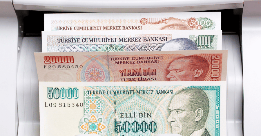 Turkish lira banknotes fanned out, each showing the Ataturk portrait