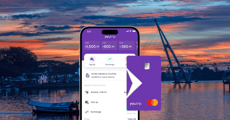 YouTrip card and app screen showing multiple currency wallets against a river sunset