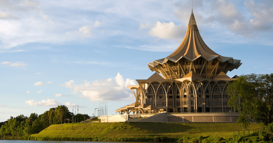 Golden spired roof of the Sarawak State Legislative Assembly above the Sarawak River at sunset