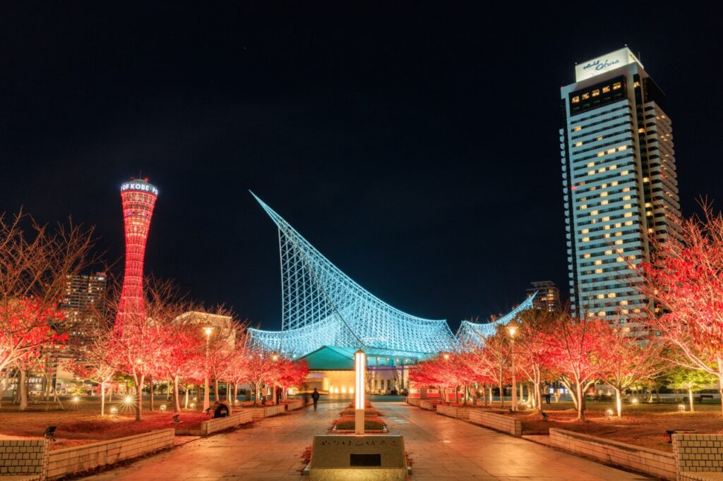 Meriken Park lit up at night with Kobe Port Tower and an illuminated art installation