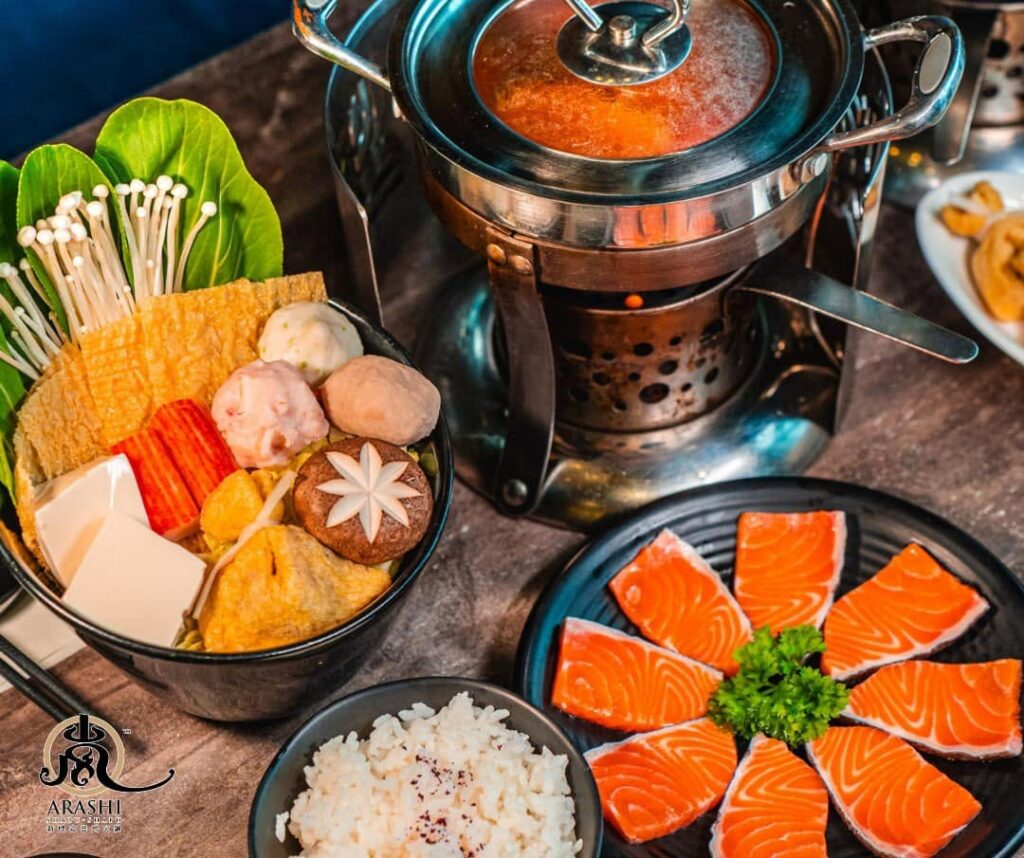 A personal hotpot set with salmon sashimi and vegetables at Arashi Shabu-Shabu