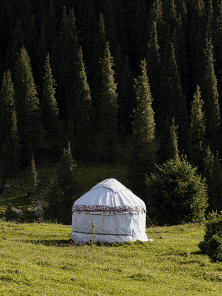 Modern-style yurts pitched in the Altyn-Arashan valley surrounded by mountains