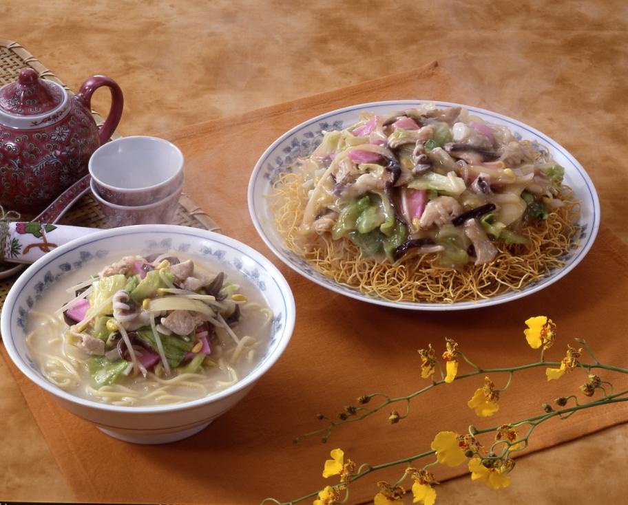 A bowl of Nagasaki champon topped with pork, shrimp, cabbage and fish cake
