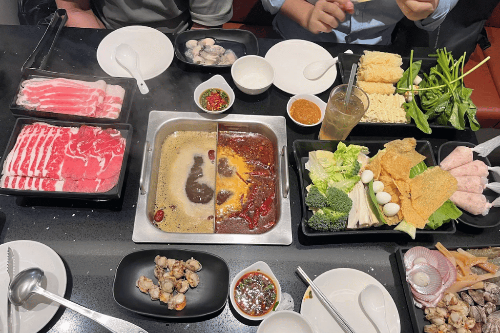 Twin-broth hotpot with sliced meats and vegetables at Hunger Hotpot in Mount Austin, Johor Bahru