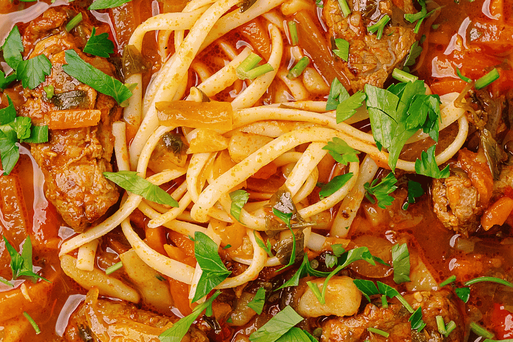 A bowl of lagman, hand-pulled noodles in a spiced meat and vegetable broth