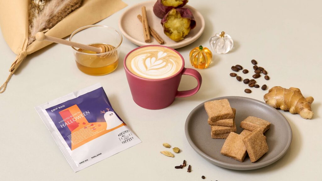 A latte, coffee beans and baked snacks styled on a table at Rokumei Coffee in Nara