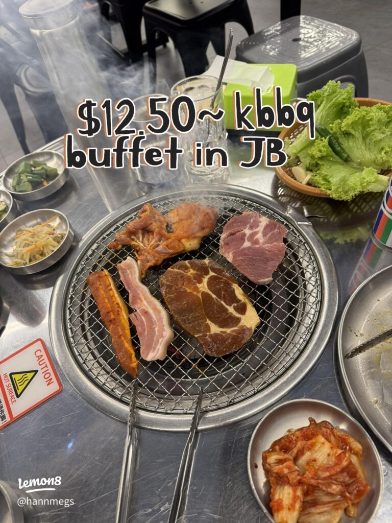 Charcoal grill loaded with pork cuts and banchan side dishes at Sae Ma Eul BBQ