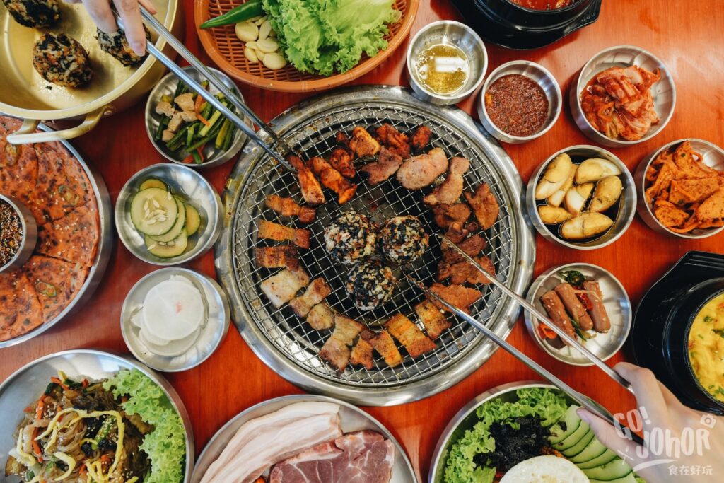 Korean BBQ grill setup with banchan sides at Sae Ma Eul BBQ Pelangi in Taman Pelangi, Johor Bahru