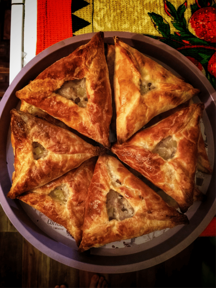 Freshly baked samsa pastries filled with minced meat and onion