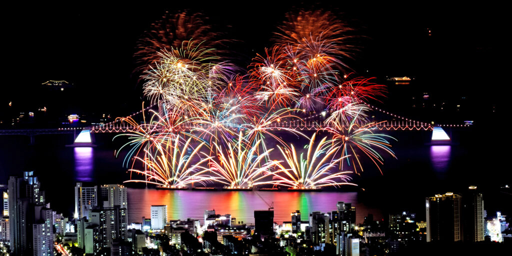 Fireworks over Gwangandaegyo Bridge and the Busan skyline during the Busan Fireworks Festival