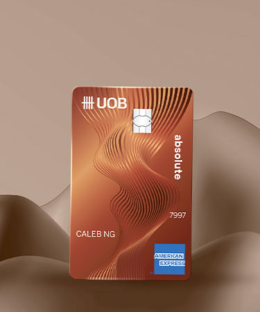 UOB Absolute Cashback American Express card on a warm bronze gradient background
