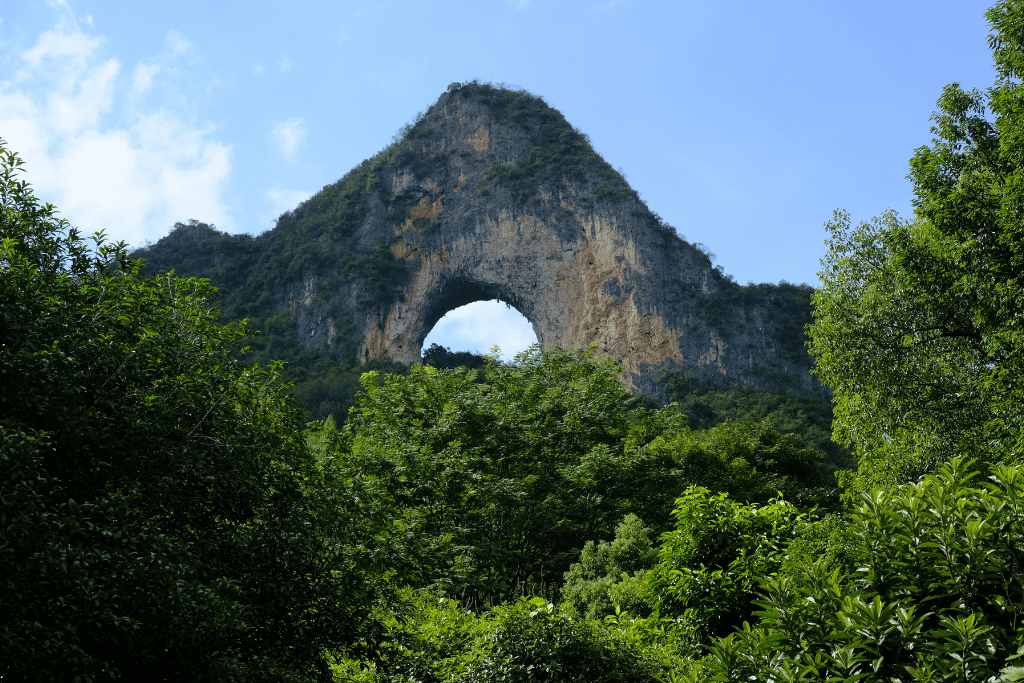 Moon Hill, a karst peak with a wide semicircular hole punched through its summit
