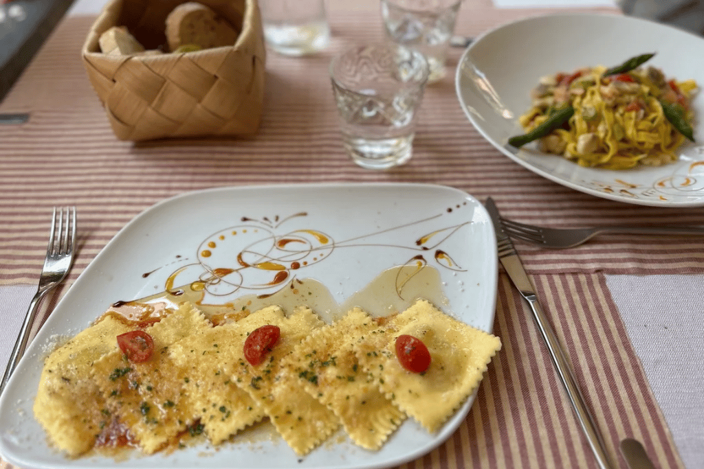 Ravioli and tagliatelle plated at Al Prato restaurant in Varenna