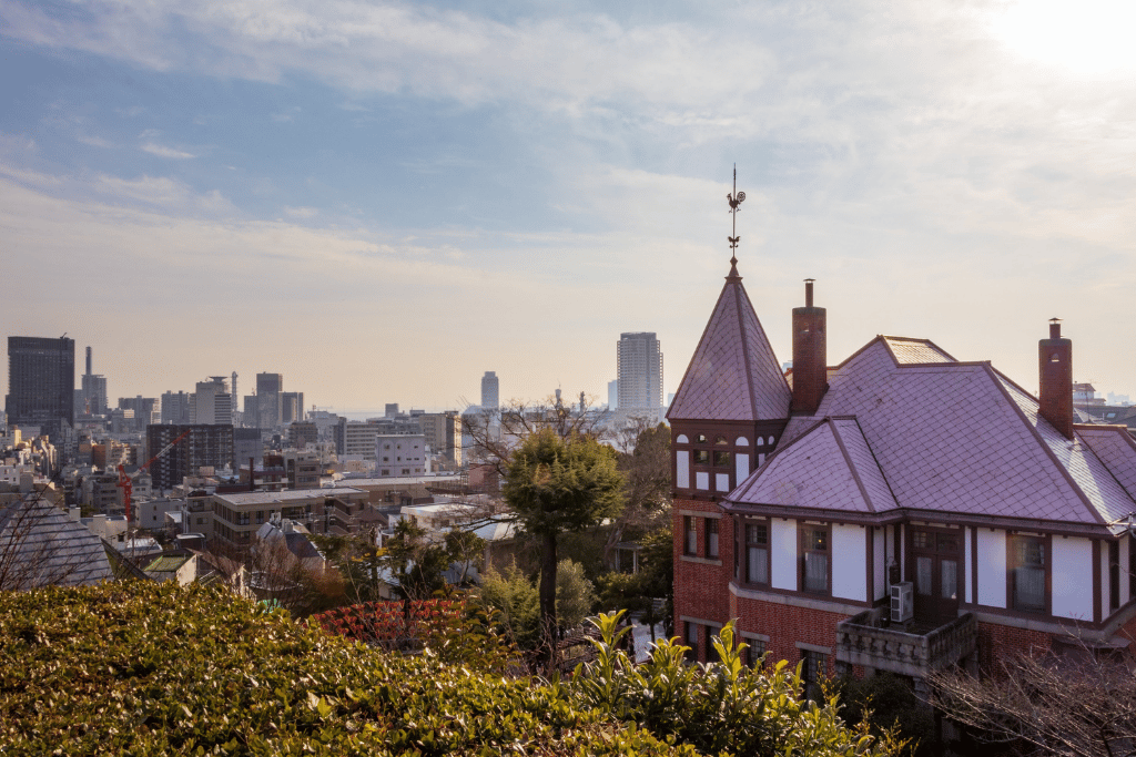 The Weathercock House's rooster-topped spire overlooking Kobe's skyline from Kitano