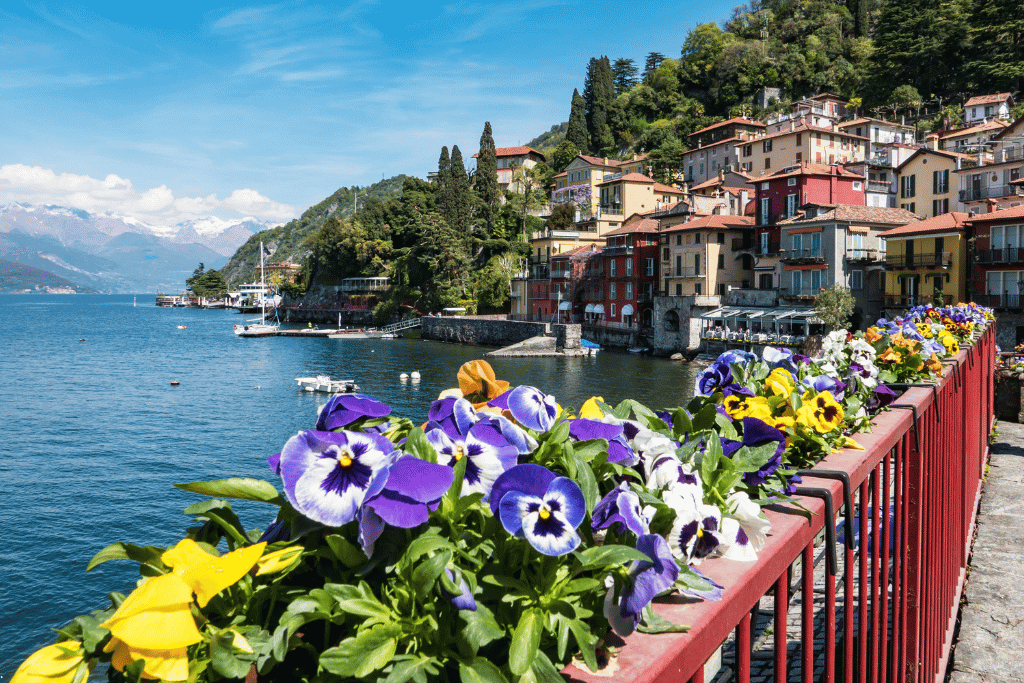Flower-lined railing overlooking Varenna's waterfront on Lake Como