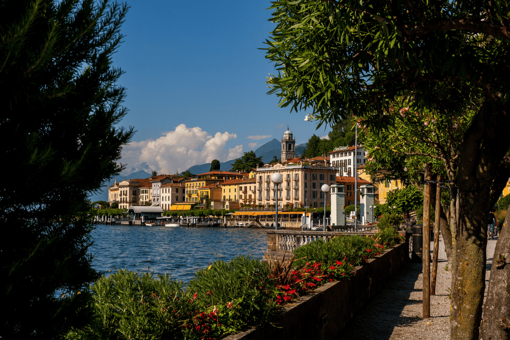 Bellagio's lakefront buildings and church tower seen through lakeside trees