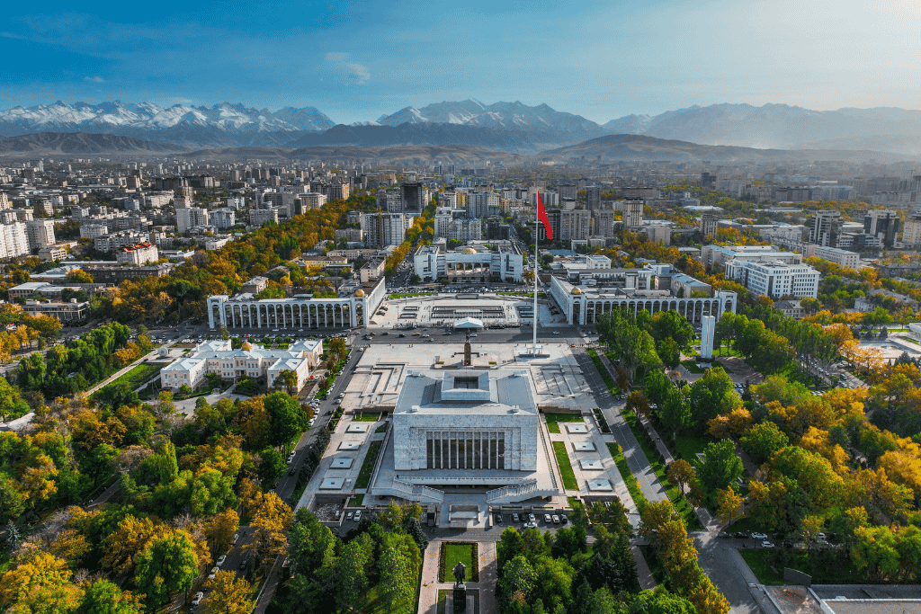 Aerial view of central Bishkek, with Ala-Too Square and government buildings backed by snow-capped mountains