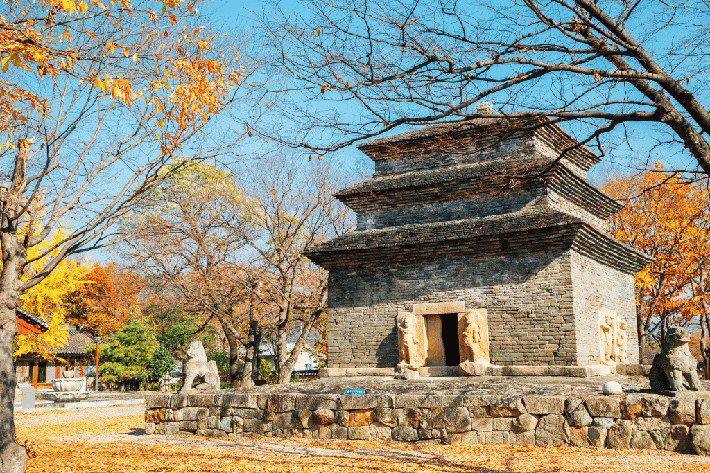 The three surviving tiers of Bunhwangsa's stone-brick pagoda, with carved guardians in the doorways