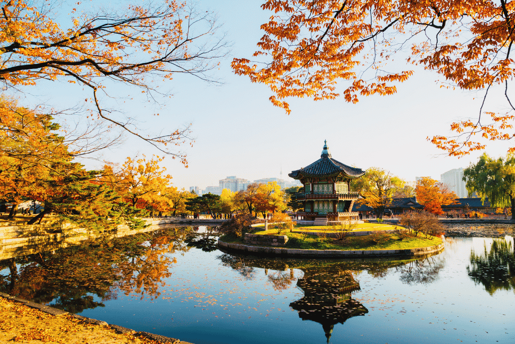 Hyangwonjeong pavilion on its pond island at Gyeongbokgung Palace, surrounded by autumn foliage