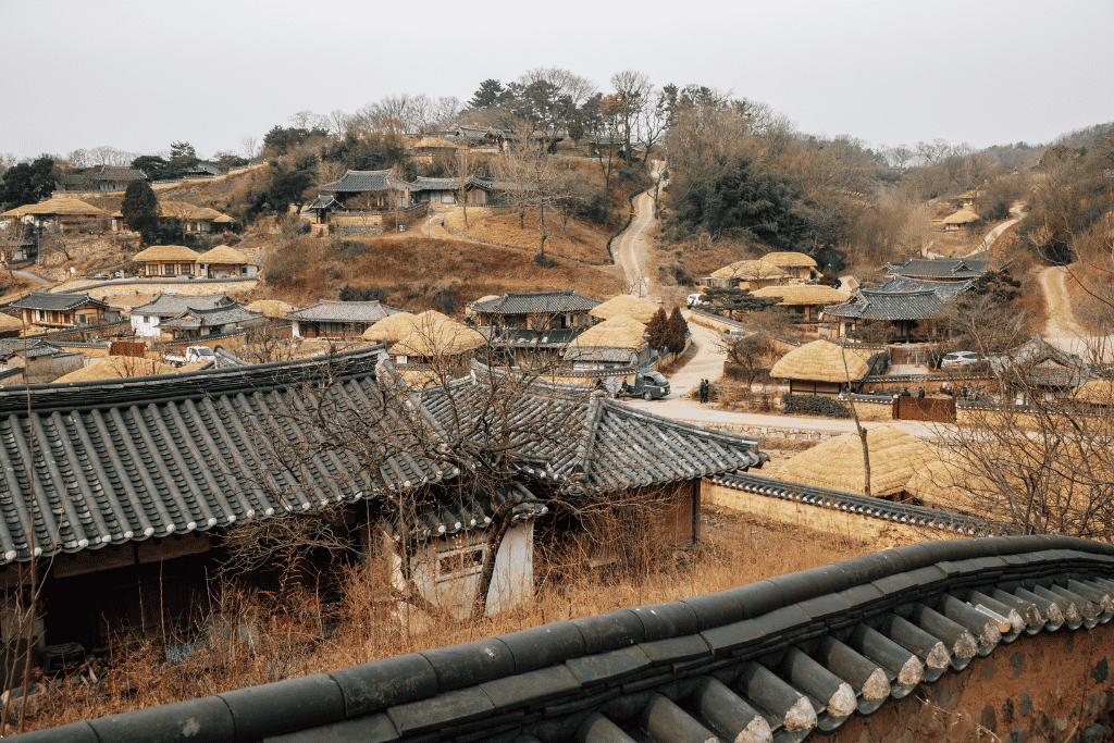 Tiled and thatched roofs of Yangdong Folk Village spread up a bare winter hillside