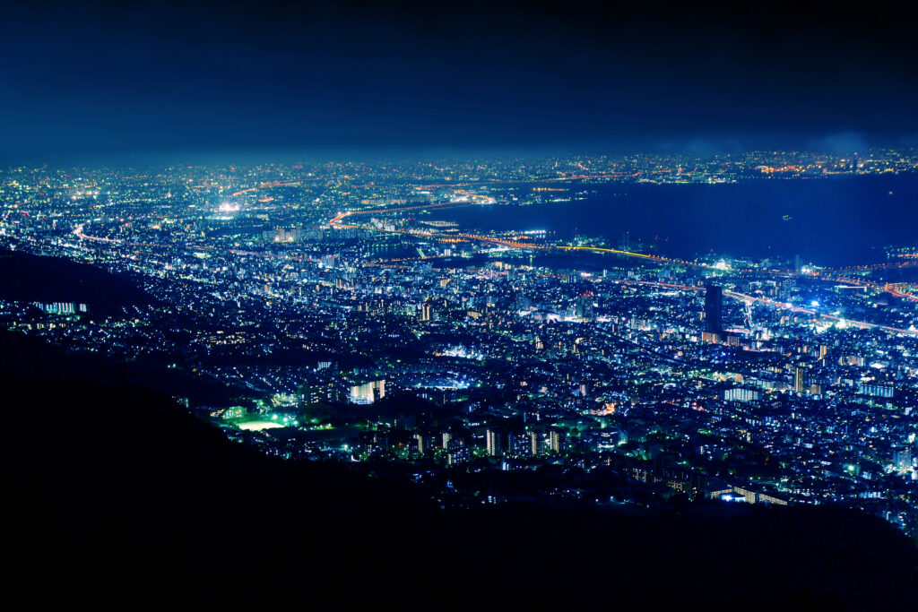 City lights spread across Kobe and the bay, seen at night from Mount Maya's Kikuseidai deck