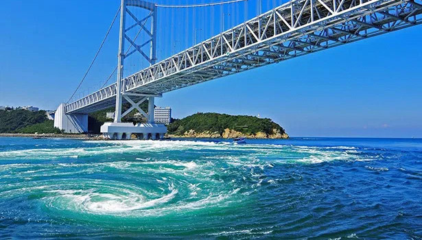 Swirling tidal whirlpools in the strait beneath the Akashi Kaikyo Bridge near Awaji Island