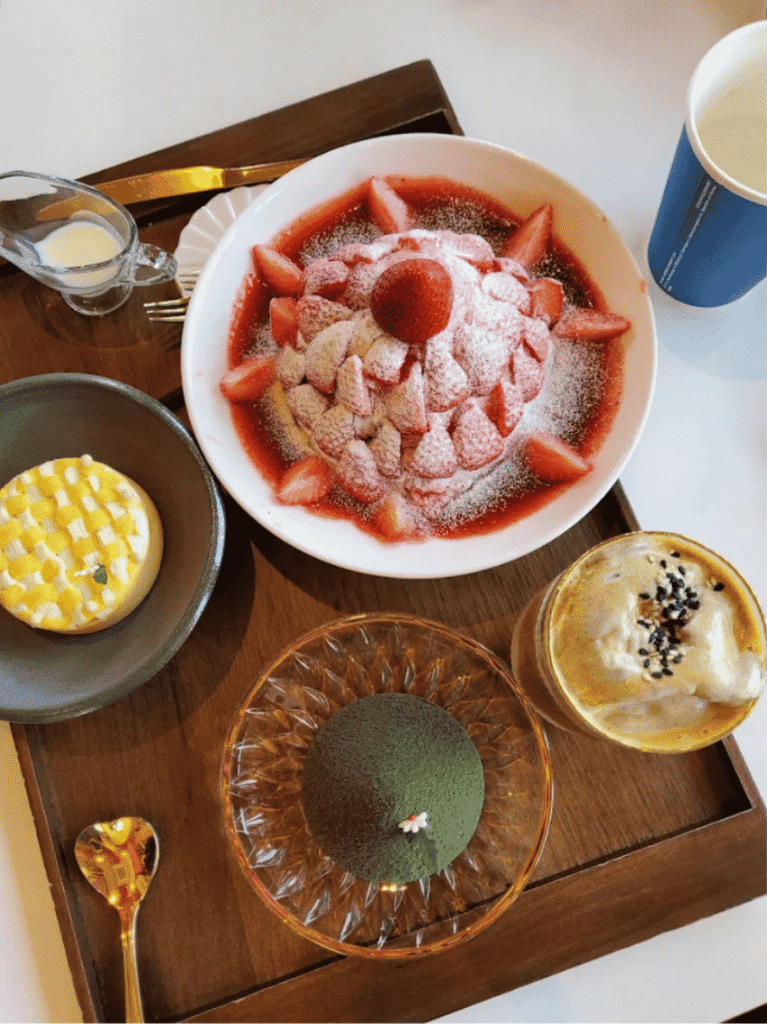 Tray at Sulwol with a green dome tart shaped like a burial mound, strawberry shaved ice and drinks