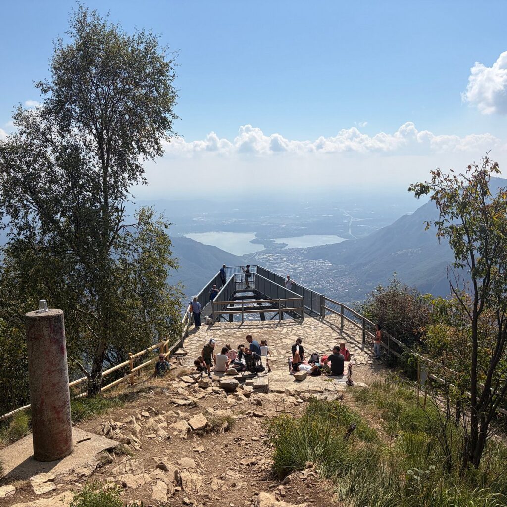 Hikers resting at the Belvedere viewpoint above Lake Como