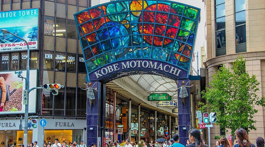 The stained-glass Kobe Motomachi arcade entrance sign above the shopping street