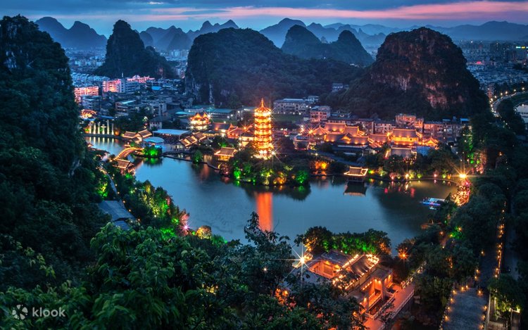 Aerial night view of Guilin's Two Rivers and Four Lakes, pagoda lit up beside the water